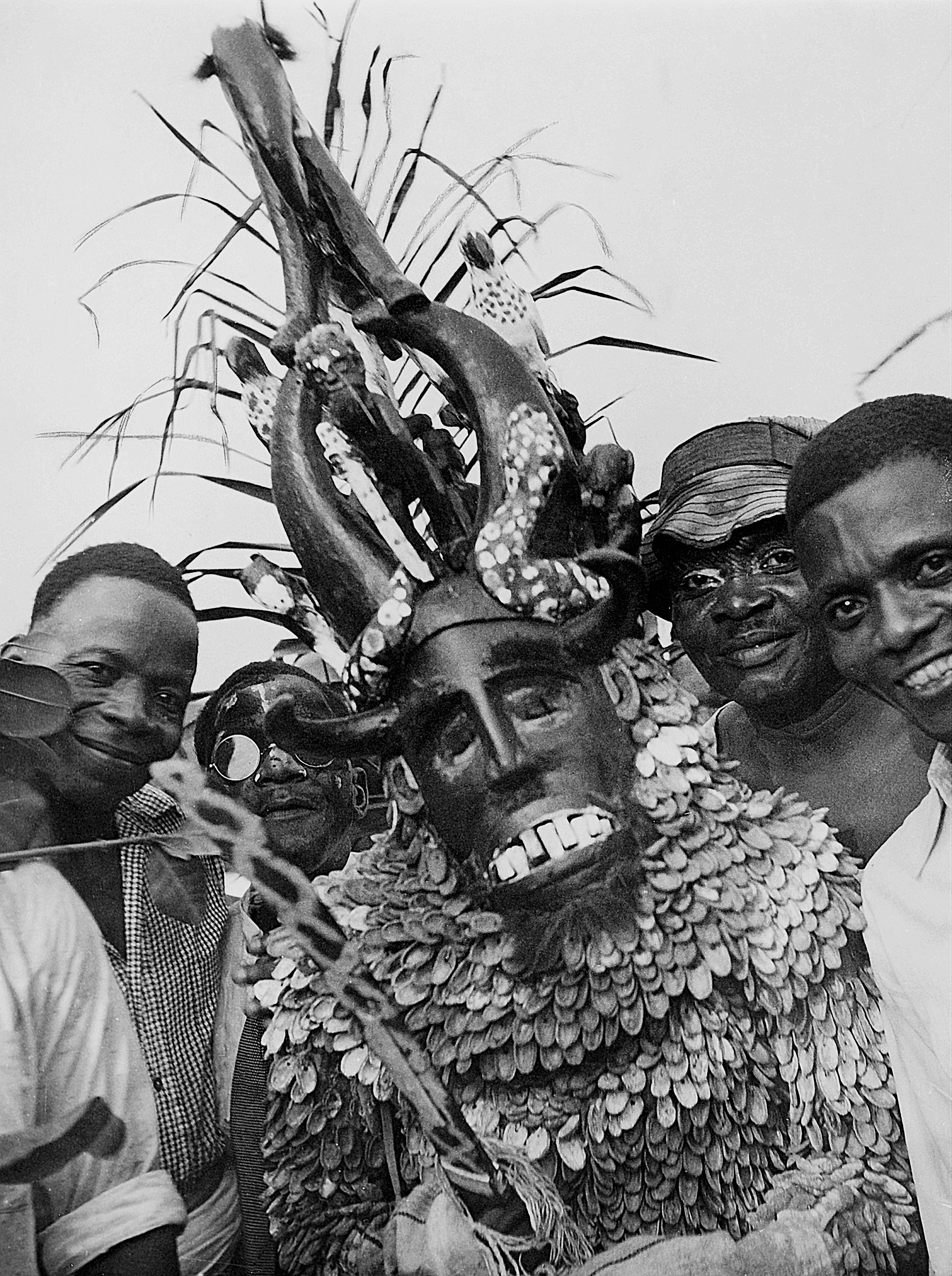 Close up image of a person in a masquerade outfit surrounded by a group of people