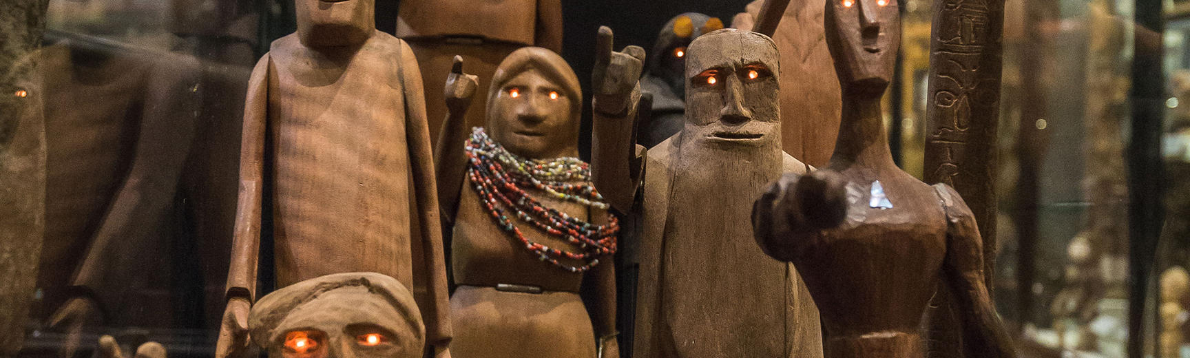Collection box of eight wooden anthropologists with glowing eyes