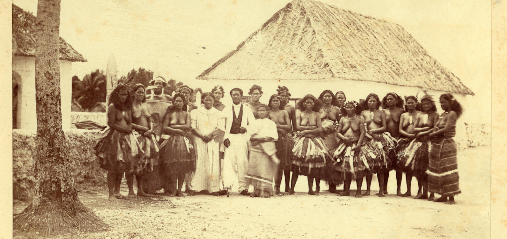 Group of men and women standing outside the Mission Station house at Nukufetau