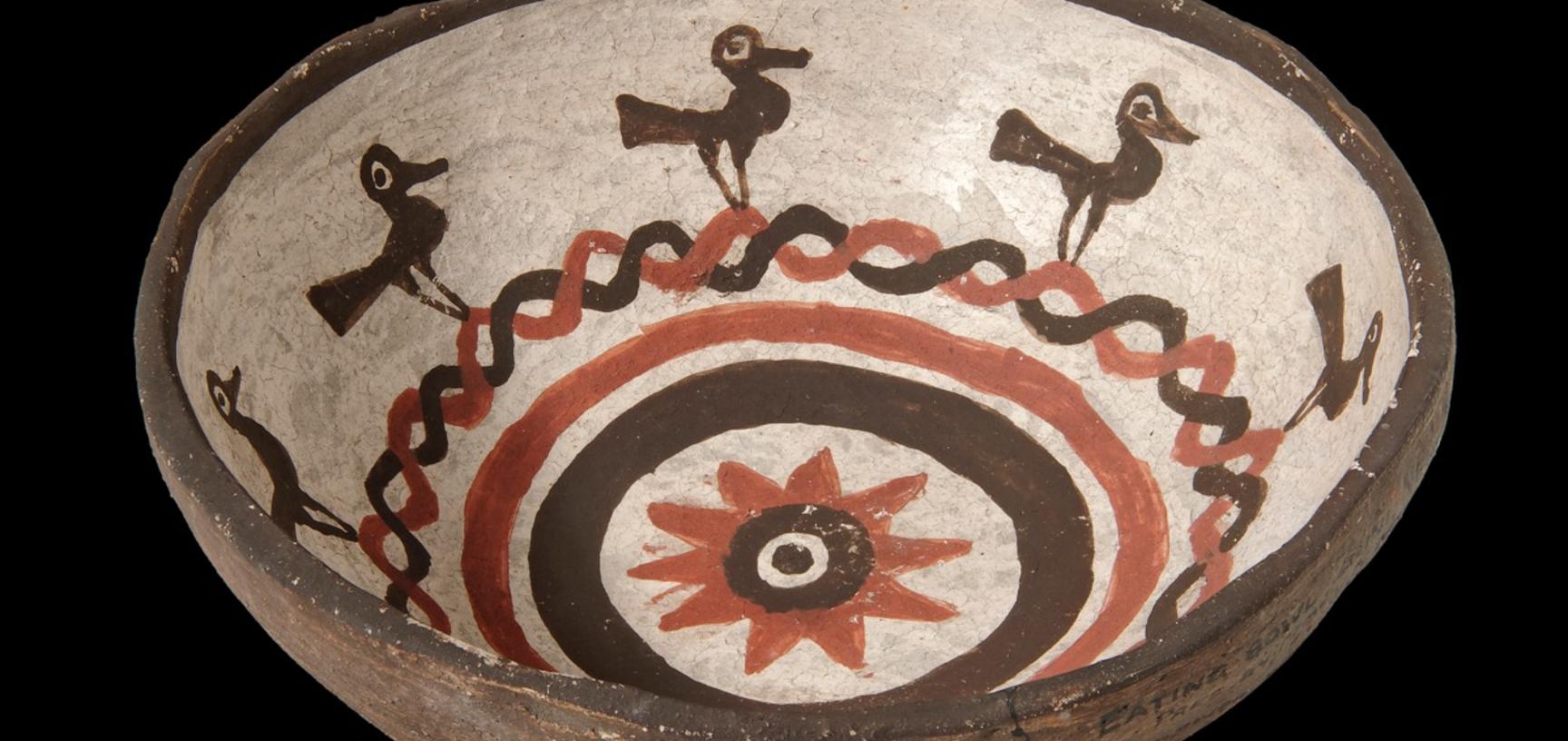Small eating bowl made in Zuni Pueblo with painted decoration of birds and a sunflower in the centre, collected by James Stevenson for the United States Geological Survey.