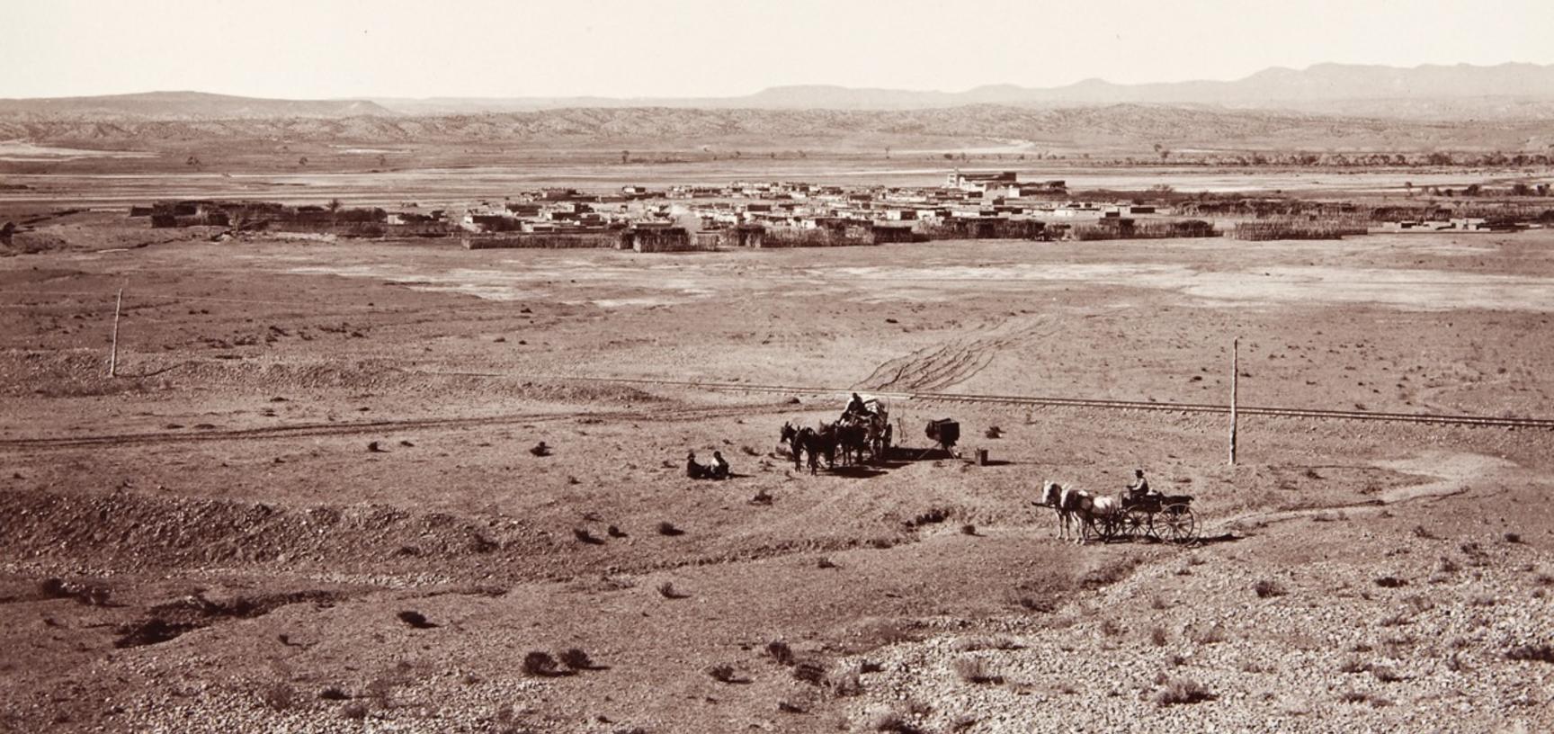 View of Santo Domingo Pueblo (present-day Kewa Pueblo), located about thirty miles south of Santa Fe, with a railway line and telegraph poles visible in the foreground. 