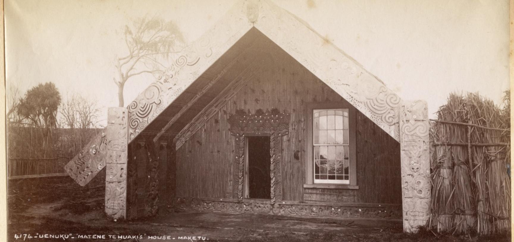 Māori house (whare) with carved and painted wooden decoration. Photograph by Alfred Burton for the Burton Brothers studio (Dunedin). North Island, New Zealand. Circa 1887.