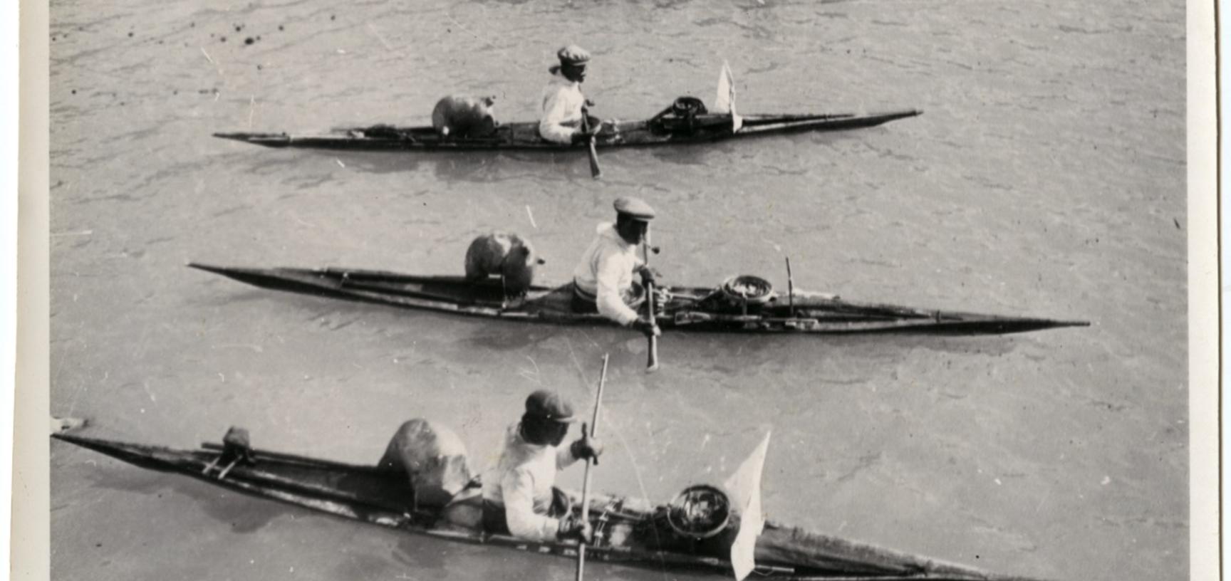 The white screens at the front of the kayaks were used to help disguise the hunters from unsuspecting seals in the water. Photograph by Henry Iliffe Cozens. Greenland. 1930–1931.