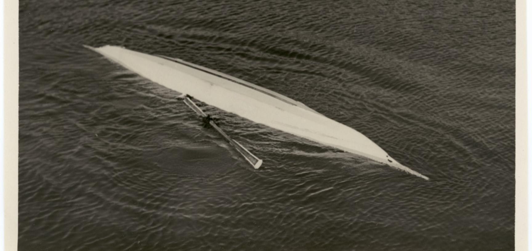 Photograph depicting one of the stages of a ‘kayak roll’, an exercise to enable kayakers to learn how to right themselves quickly if capsized in freezing waters. Photograph by Henry Iliffe Cozens. Greenland. 1930–1931.