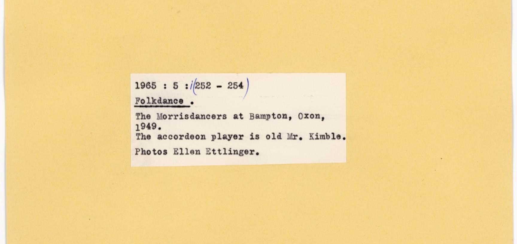 Reverse of the previous index card with typed label for notes and attribution: Folkdance. The Morrisdancers at Bampton, Oxon, 1949. The accordeon player is old Mr. Kimble. Photos Ellen Ettlinger