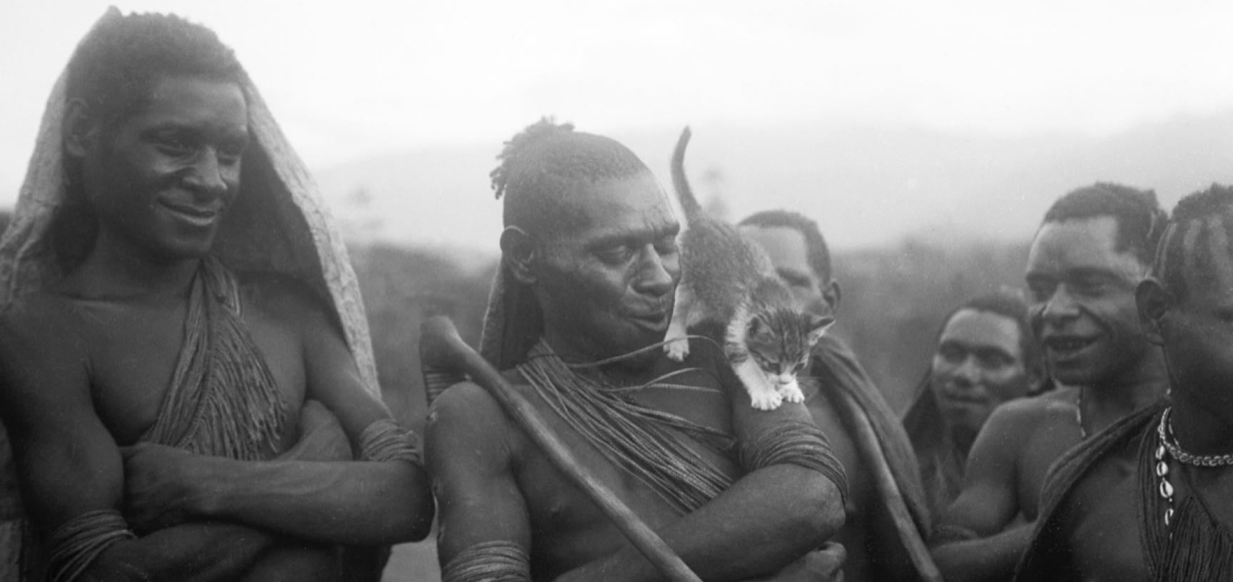 Various warriors of the Anga people with a cat standing on the shoulders of the central figure