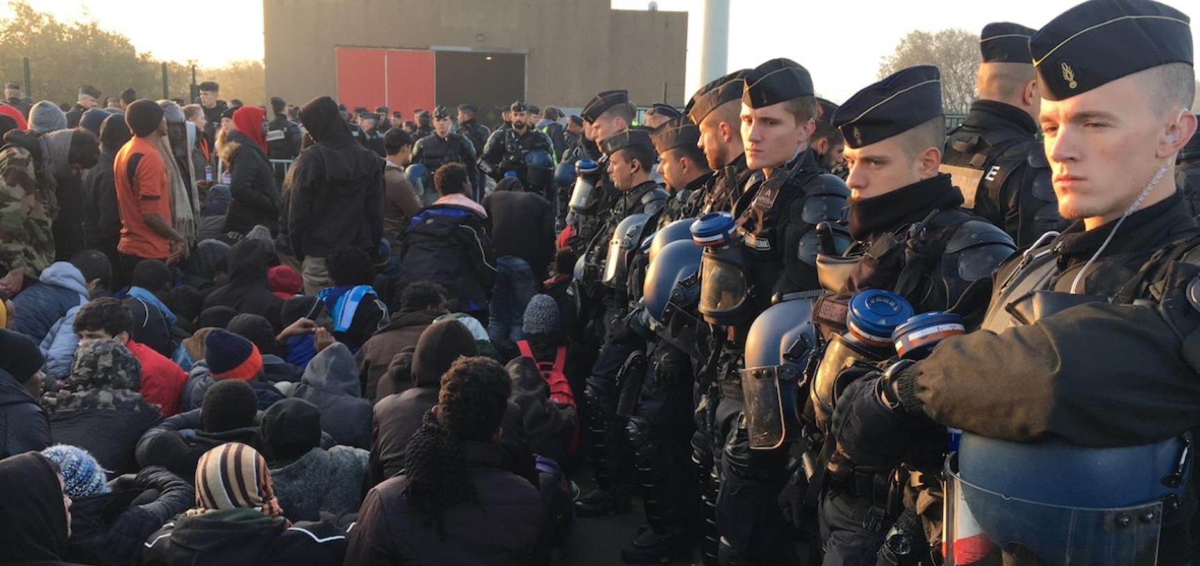 Migrants waiting to enter the hangar at Calais.