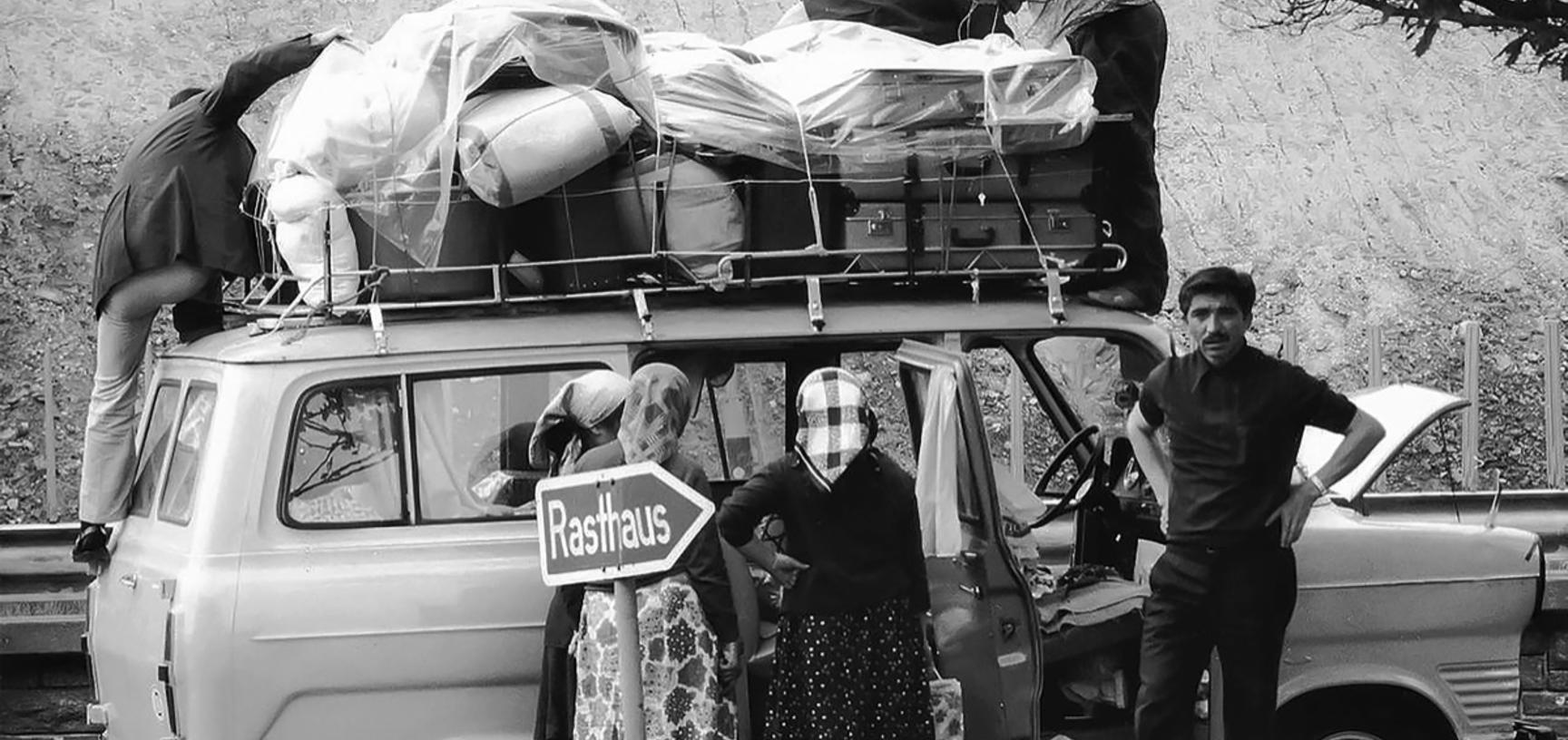 Immigrants packing their belongings on a van