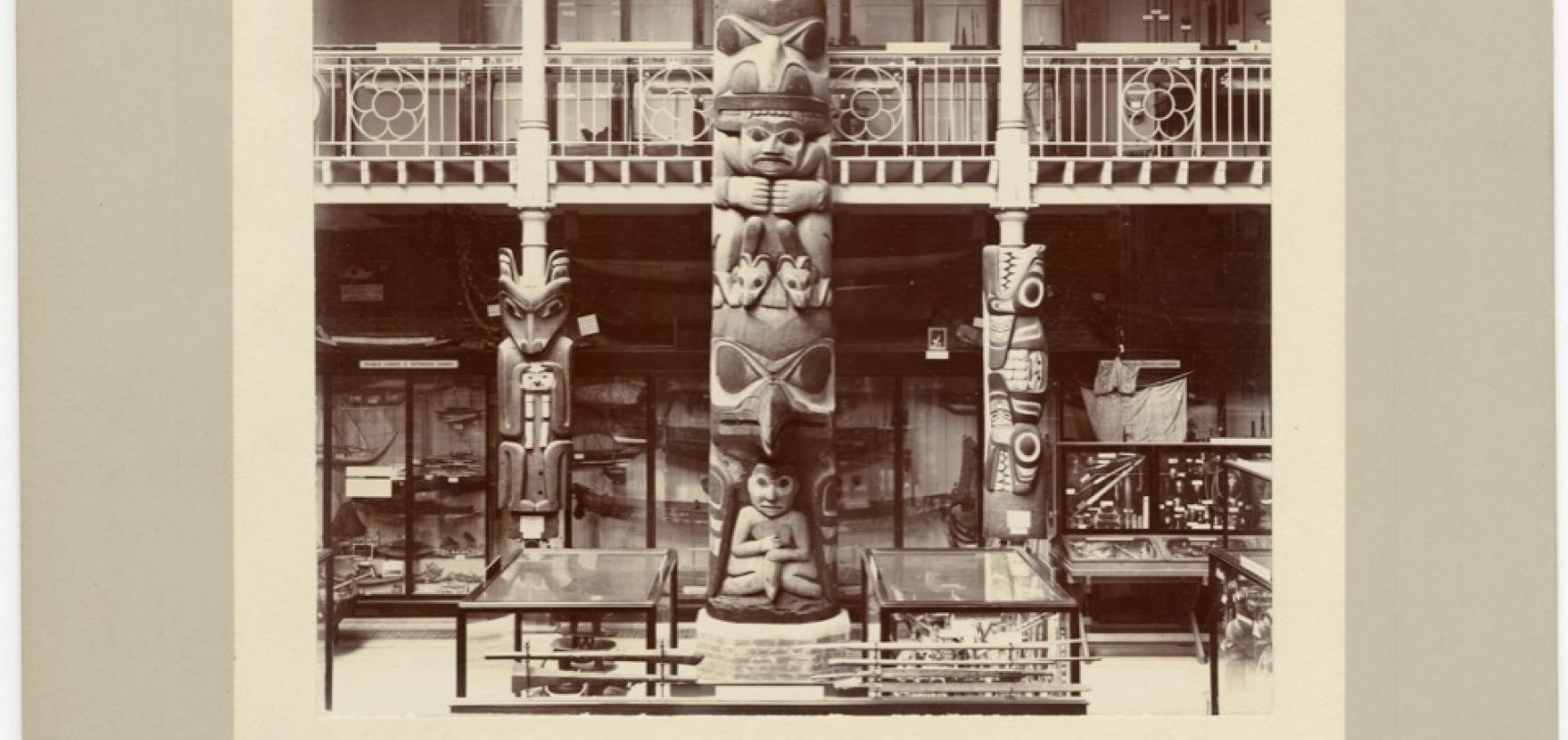 Interior view of the Pitt Rivers Museum, looking towards the east end of the Court, showing the Haida totem pole (‘Star House Pole’). Photograph by Alfred Robinson. Oxford, England. 1901. (Copyright Pitt Rivers Museum, University of Oxford. Accession Numb