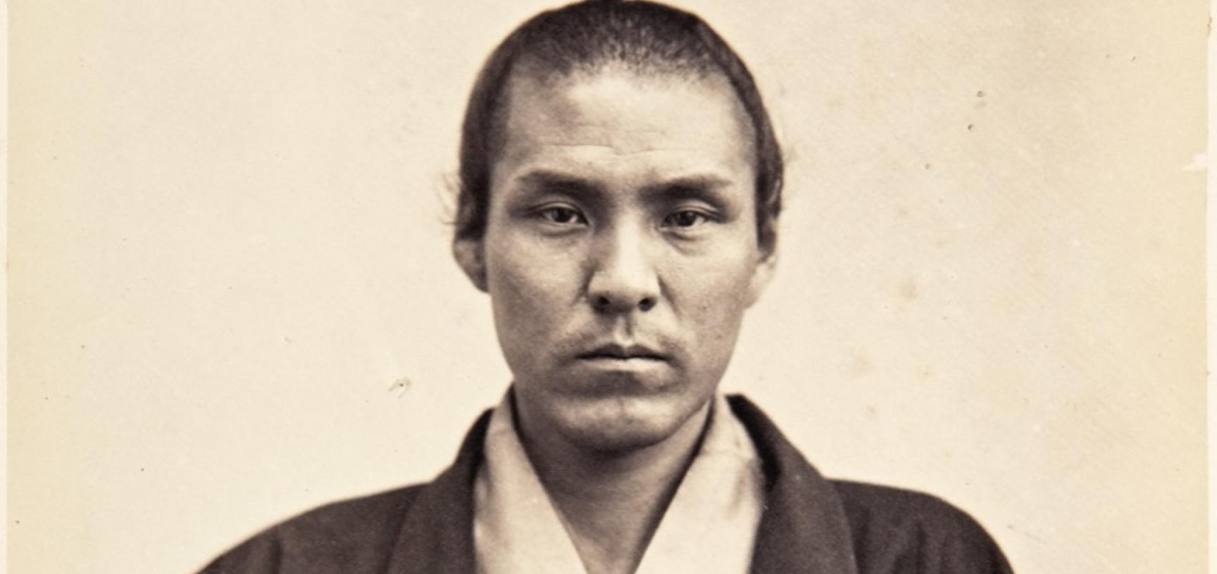 Portrait of Taichi Tanabe with traditional clothes and weapons