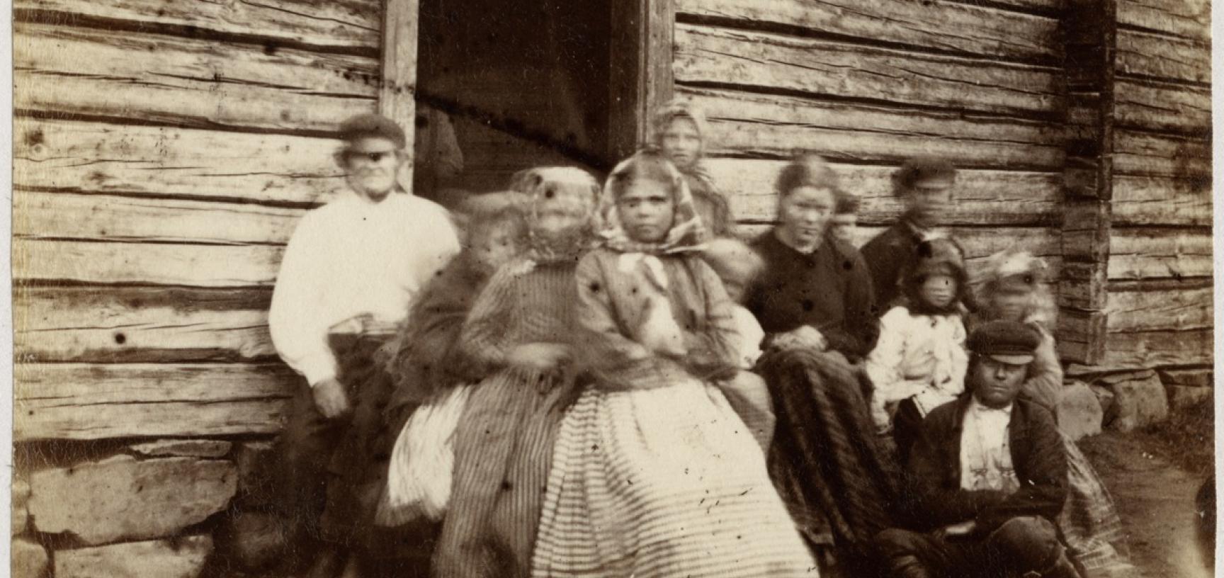 Portrait of a Finnish family. In his diary Evans described photographing such a group: ‘At Rungam, where we once more crossed the river Kemi, I tried taking a photograph of a large group of Finns, & actually succeeded in getting them to sit, but when the 