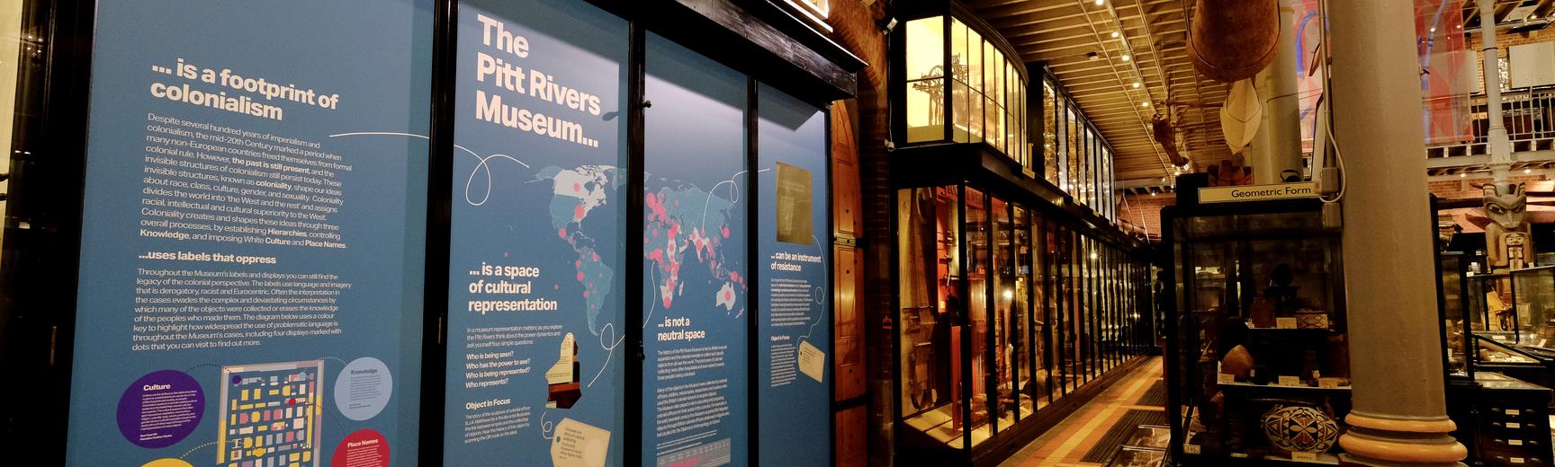 View of galleries with blue information panels displaying maps and images.