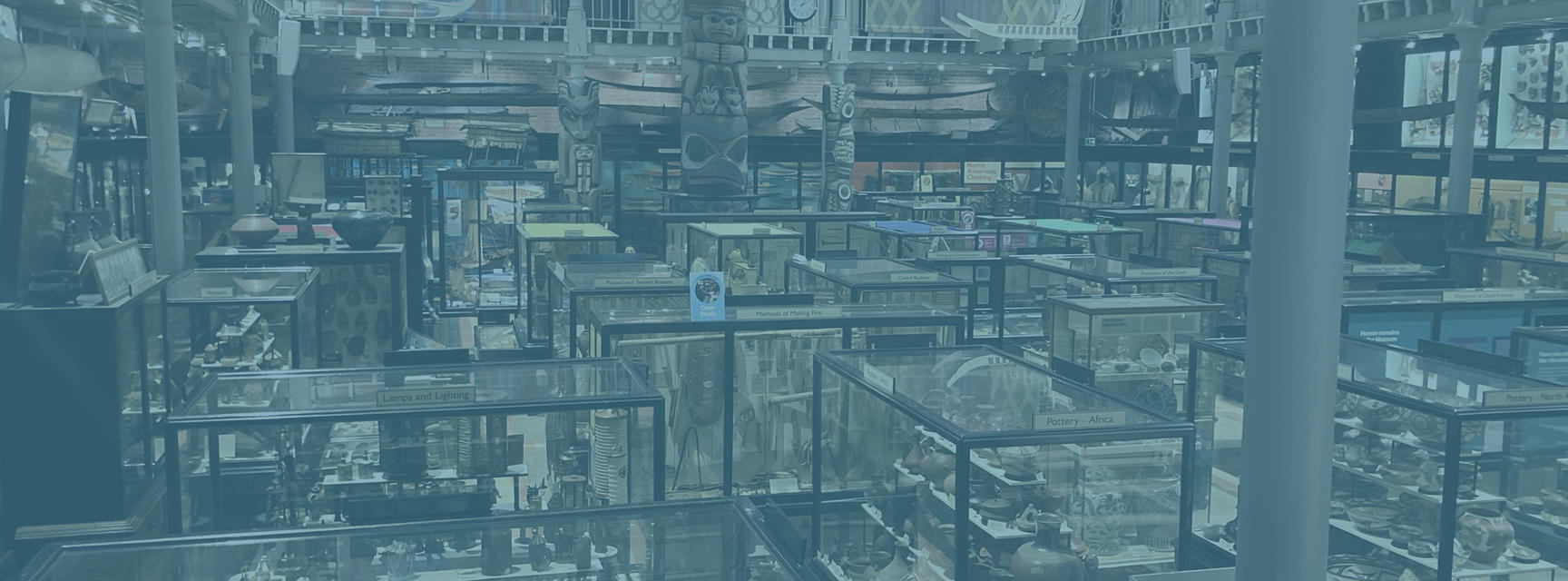 View of the interior of the Pitt Rivers Museum with a blue filter. 