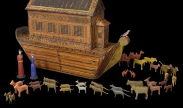 Wooden boat with animals in pairs and two human figurines 