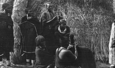 Group of Zulu women dressing each other's hair. 