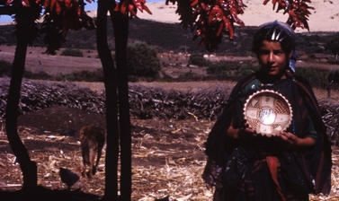 A young Amazigh woman selling pottery in Sejnane.