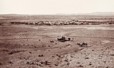 View of Santo Domingo Pueblo (present-day Kewa Pueblo), located about thirty miles south of Santa Fe, with a railway line and telegraph poles visible in the foreground. 