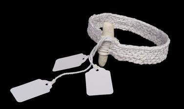 Arm band made from woven white material with small white parcel tags attached.
