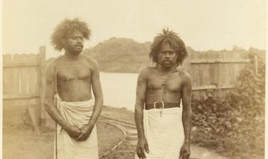 Portrait of two Fijian men, labourers, pictured beside the Rewa River. Photograph by Alfred Burton for the Burton Brothers studio (Dunedin). Viti Levu, Fiji. June 1884.