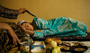 A healer works to cure tiredness due to a recent bereavement. Dushanbe, Tajikistan. Photograph by Carolyn Drake. July 2008.