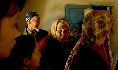 Guests enter a village home during the annual Navrus festival. Shege, Uzbekistan. Photograph by Carolyn Drake. March 2008.