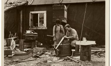 Expedition member working alongside an Inuit woman. 