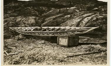 One of the various stages in the construction of a kayak by Inuit, here showing its underlying wooden frame. Photograph by Henry Iliffe Cozens. Greenland. 1930–1931.