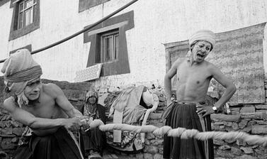Buchen dressed as beggars undertake a tug of war, during a performance of ‘The Elephant’, a scene from the story of Prince Drimed Kunden. Photograph by Patrick Sutherland. Lara, Spiti, Himachal Pradesh, India. 2004.