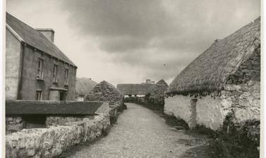  An empty street with thatched cottages on Aran Isles