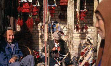 People at a trader’s stall in Kashgar