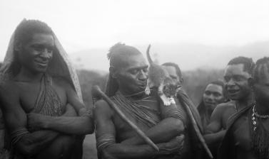 Various warriors of the Anga people with a cat standing on the shoulders of the central figure