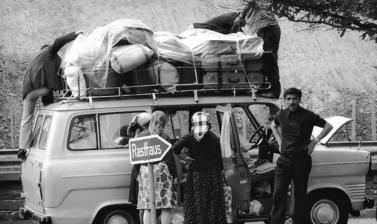 Immigrants packing their belongings on a van