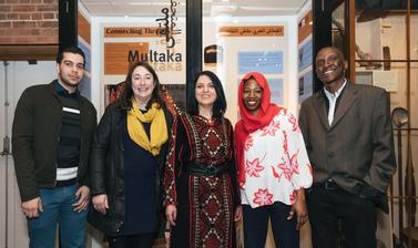 Multaka-Oxford volunteers and co-curators of the ‘Connecting Threads’ exhibition pictured in front of the display case.