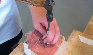 hand engraving a block of wood