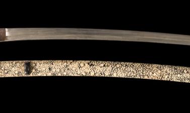 This katana, or long sword, nearly a metre in length, has at some point in its history been shortened (by removing part of the tang, including some of the signature). Certain features of the blade, however, suggest that it was made by a (lesser) smith of 