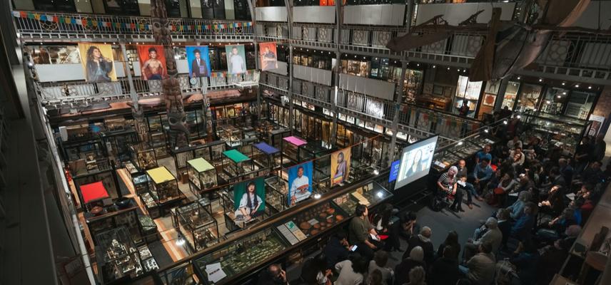 A crowded audience of Tibetans and others watch a video message from Nyema Droma at a public engagement event held at the Pitt Rivers Museum in April 2019.