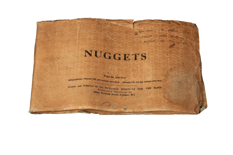 A landscape booklet of crinkly yellowed paper and worn edges, punctured with braille holes, with the title 'NUGGETS' printed as a central title.