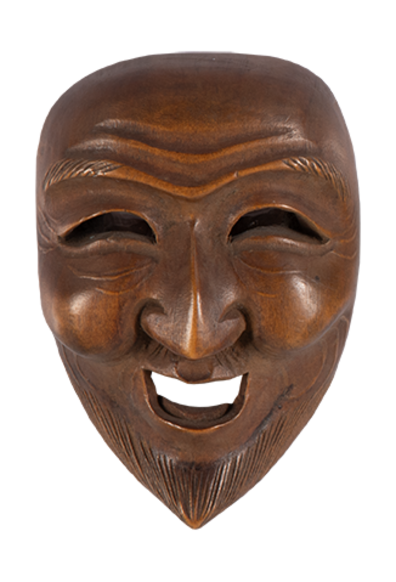 A small wooden face mask carved with an open smiling mouth and furrowed brow.