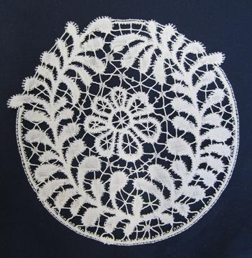 Circle of white lace on a black background