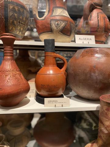 Collection of terracotta coffee pots in display case