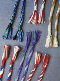 Multicoloured woven tubular cords