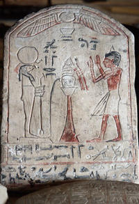 Ancient Egyptian plaque with drawings and hieroglyphs