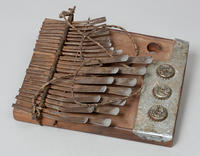 Mbira from Zimbabwe. Wooden with metal prongs & bottle caps.
